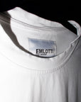 EMLOTTI Designs Karma T-Shirt. Black image of woman with the phrase "Art of Karma" printed on white 100% pre-washed cotton tee. Close-up of custom tag.