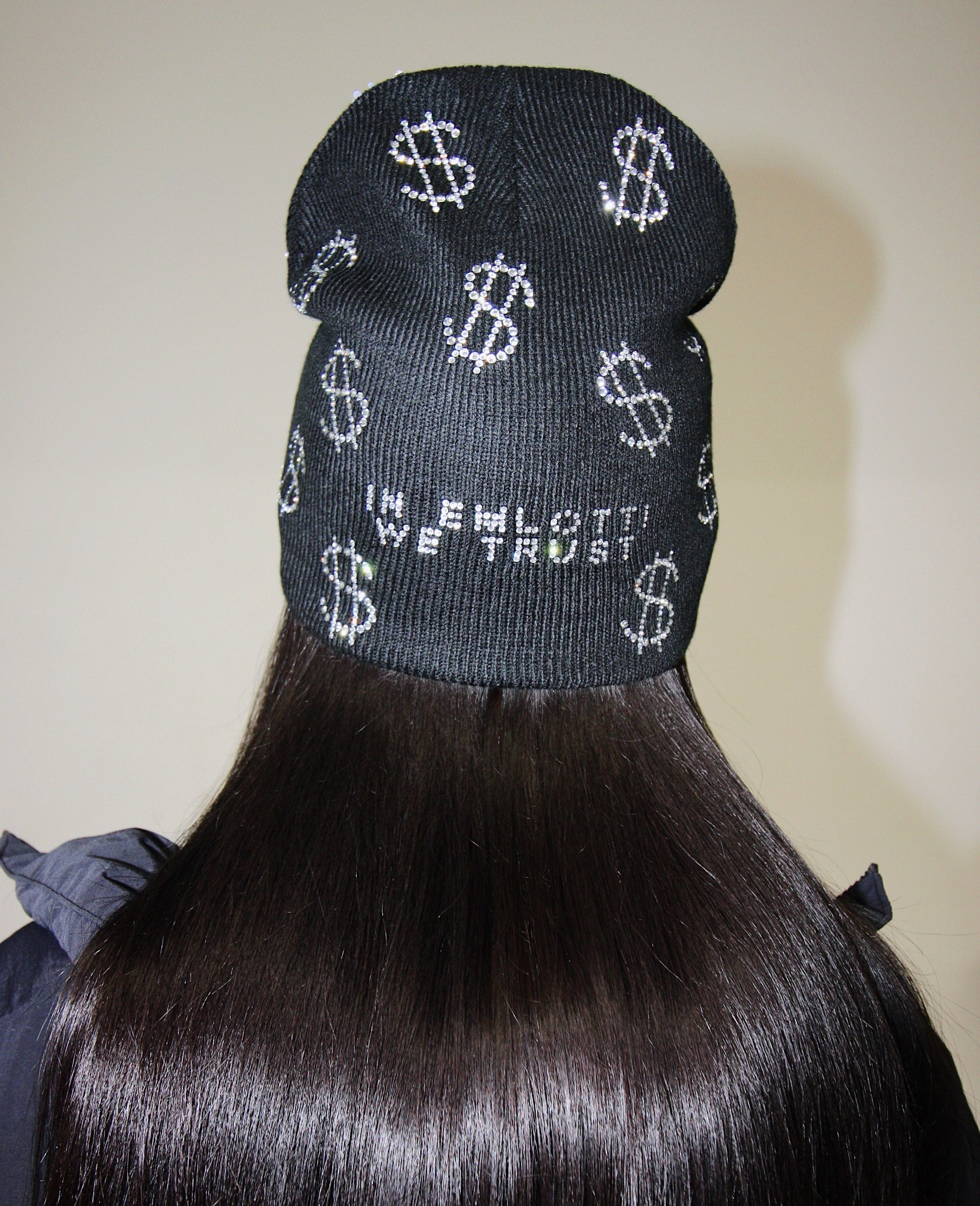 Black knit beanie with money signs in rhinestones by EMLOTTI.